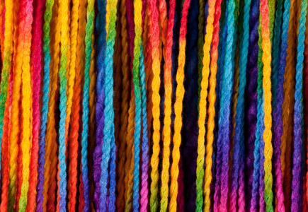 rainbow coloured string hanging vertically