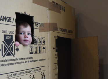 kid poking head out of box