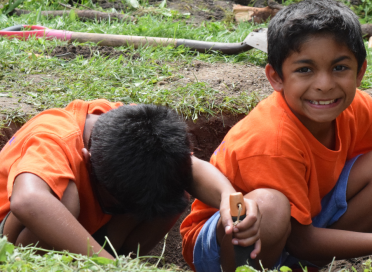 two boys digging in the dirt