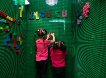 children play at lego wall