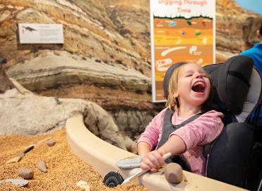 child plays at dig pit