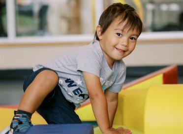 toddler climbs soft blocks