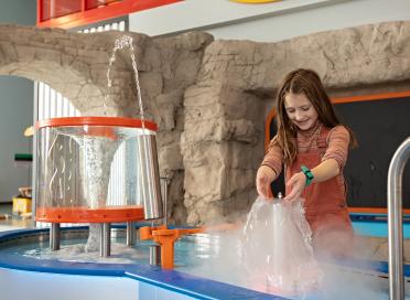 Child plays with water feature